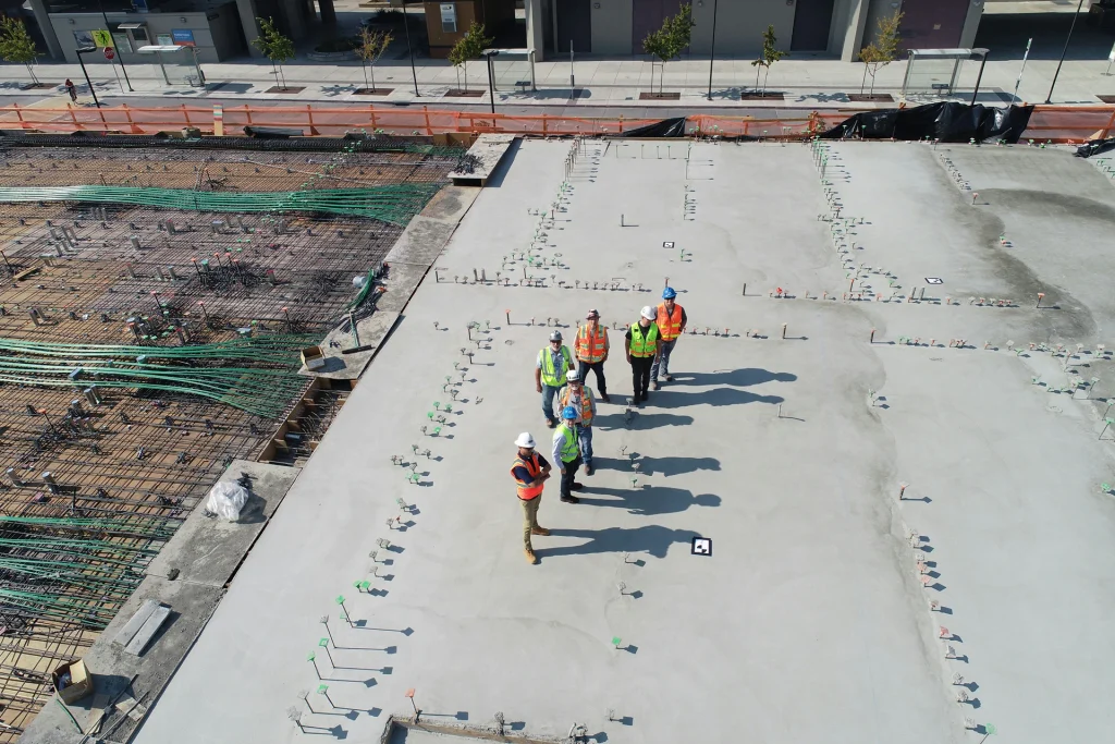 Construction team standing on a concrete jobsite