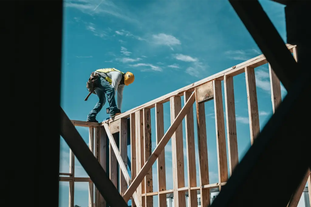 Construction worker framing a wood structure